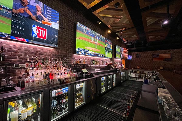 View of the Bar and TVs at The Whistle Sports Bar & Grill in Chicago