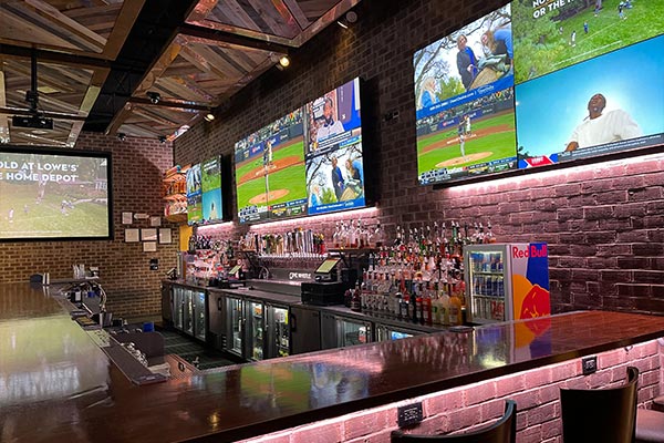 View of the Bar and projector screen at The Whistle Sports Bar & Grill in Chicago